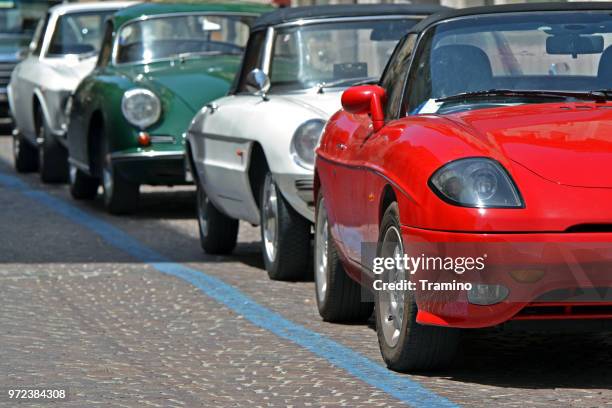 classic coupe and cabriolet vehicles - alfa romeo spider stock pictures, royalty-free photos & images