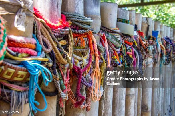 bracelets left in tribute at the killing fields in phnom penh, cambodia - khmer genocide stock pictures, royalty-free photos & images