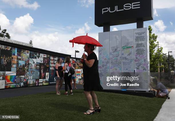 People visit the memorial set up for the shooting victims at Pulse nightclub where the shootings took place two years ago on June 12, 2018 in...