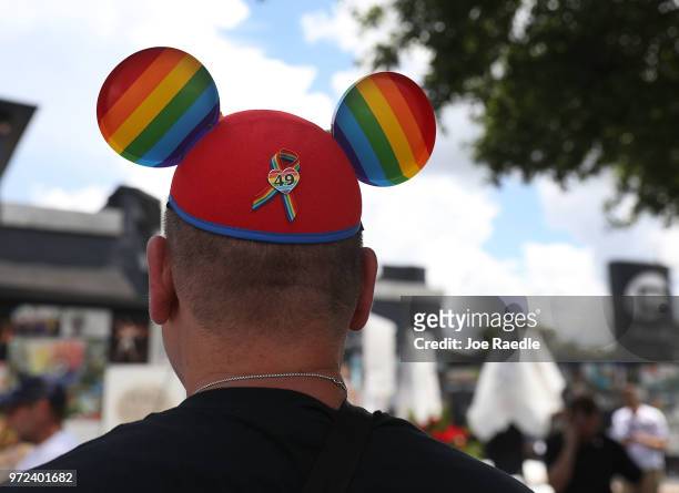 Jimmy D'Ambrosia wears a Mickey Mouse ears hat as he spends time at the memorial set up for the shooting victims at Pulse nightclub where the...