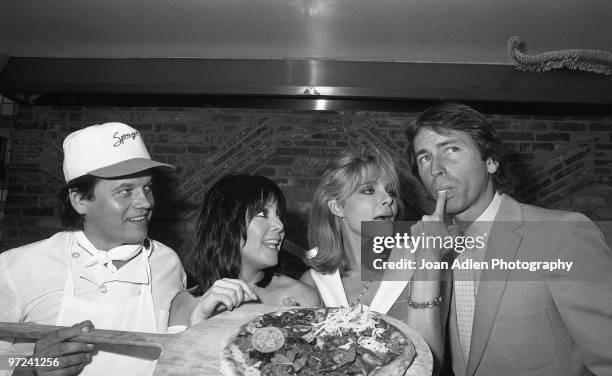 Celebrity Chef Wolfgang Puck serves actors and stars of the sitcom 'Three's Company' Joyce DeWitt, Priscilla Barnes and John Ritter at his restaurant...