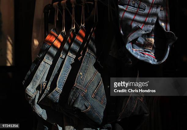 Jeans hang in a window for sale in the SoHo shopping district of Manhattan March 1, 2010 in New York City. Consumer spending numbers tracked slightly...
