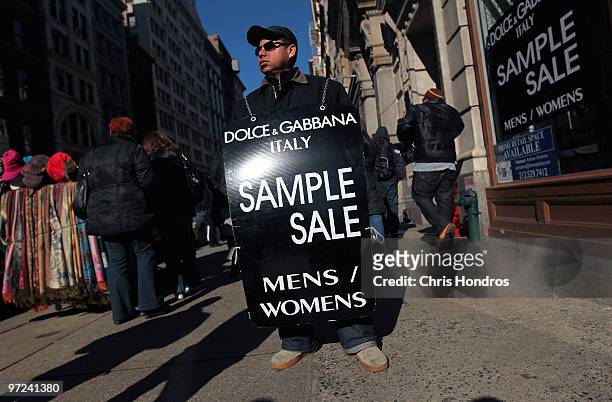 Worker carries a sandwich board advertising a sale in the SoHo shopping district of Manhattan March 1, 2010 in New York City. Consumer spending...