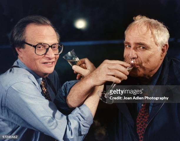 Actor Marlon Brando plants one on talk show host Larry King during the taping of "The Larry King Show' taped at Brando's house in Coldwater Canyon on...