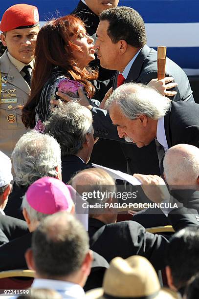 Argetine President Cristina Kirchner kisses her Venezuelan counterpart Hugo Chavez before the Uruguayan Government inauguration ceremony of newly...