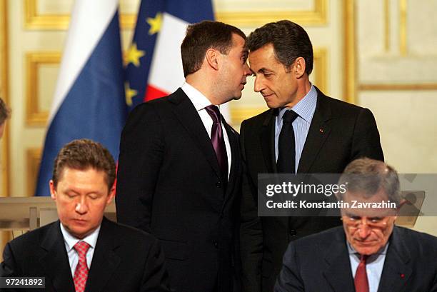 Russian President Dmitry Medvedev and France's President Nicolas Sarkozy stand behind head of Russian Gazprom State Company Alexei Miller and French...