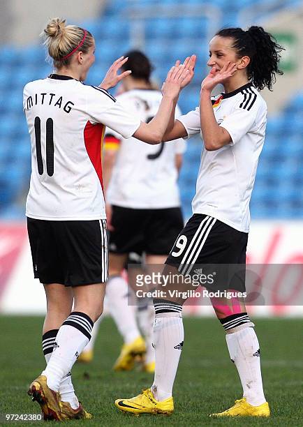 Anja Mittag and Fatmire Bajrmaj celebrate the goal of Germany during the Woman Algarve Cup match between Germany and China at the Estadio Algarve on...