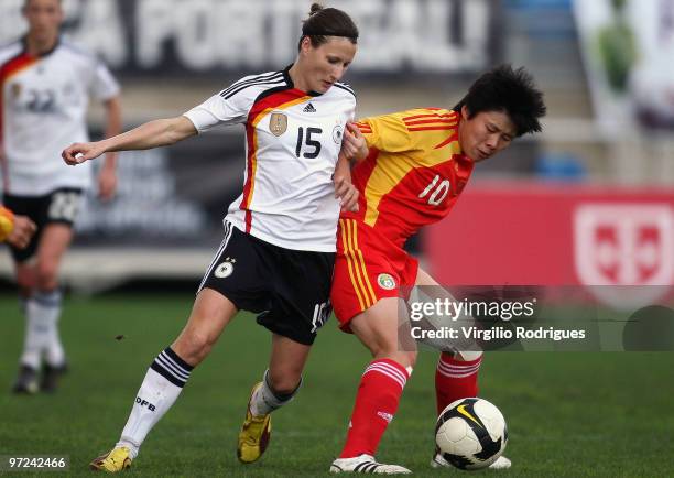 Sonja Fuss of Germany and Ma Xiaoxu of China battle for the ball during the Woman Algarve Cup match between Germany and China at the Estadio Algarve...