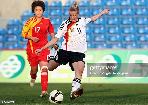 Anja Mittag of Germany and Pang Fengyue of China battle for the ball during the Woman Algarve Cup match between Germany and China at the Estadio...