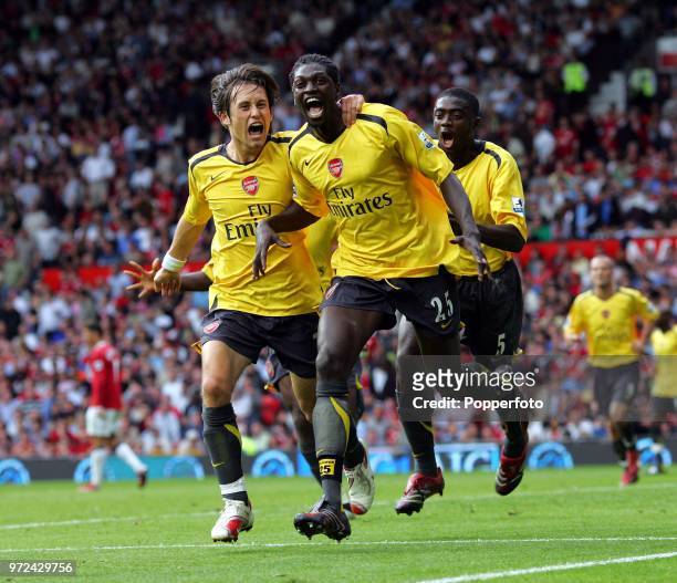 Emmanuel Adebayor of Arsenal celebrates with teammates Tomas Rosicky and Kolo Toure during the Barclays Premiership match between Manchester United...