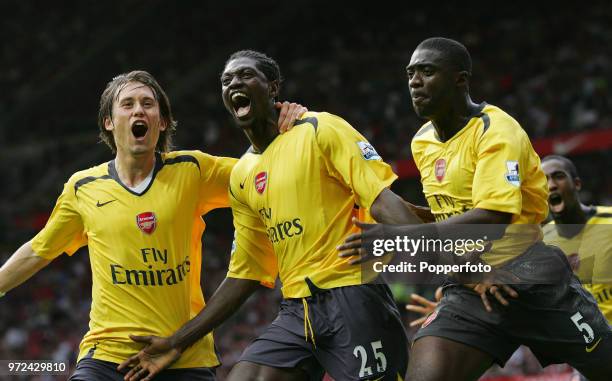 Emmanuel Adebayor of Arsenal celebrates with teammates Tomas Rosicky and Kolo Toure during the Barclays Premiership match between Manchester United...