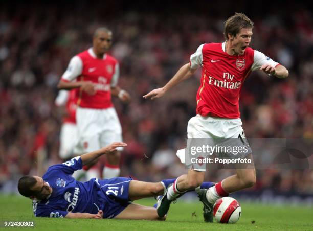 Alexander Hleb of Arsenal is brought down by Leon Osman of Everton during the Barclays Premiership match between Arsenal and Everton at The Emirates...