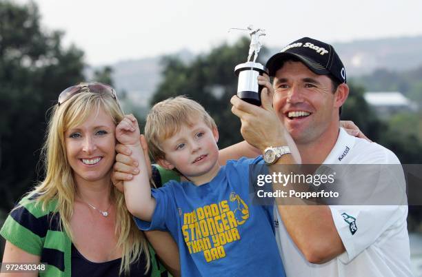 Padraig Harrington of Ireland poses with the Vardon Trophy alongside his wife Caroline and son Patrick after winning The Order of Merit at the Volvo...