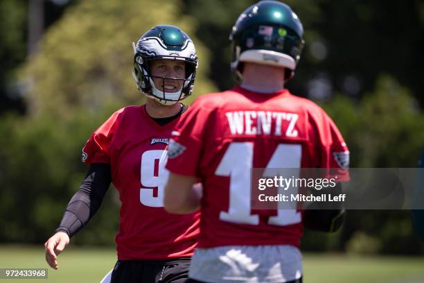 Nick Foles of the Philadelphia Eagles talks to Carson Wentz during Eagles minicamp at the NovaCare Complex on June 12, 2018 in Philadelphia,...