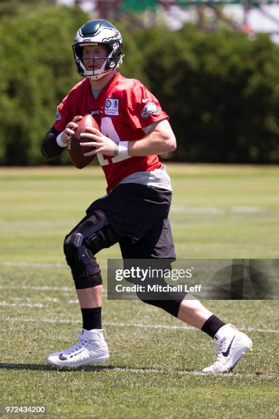 Carson Wentz of the Philadelphia Eagles looks to pass the ball during Eagles minicamp at the NovaCare Complex on June 12, 2018 in Philadelphia,...