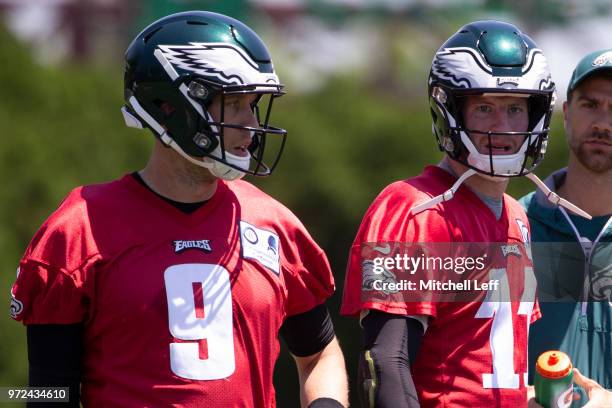 Nick Foles and Carson Wentz of the Philadelphia Eagles look on during Eagles minicamp at the NovaCare Complex on June 12, 2018 in Philadelphia,...