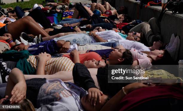 Protesters participate in a die-in to mark the anniversary of the Pulse nightclub shooting, Tuesday, June 12 in West Palm Beach across the water from...