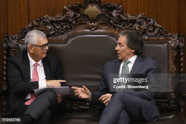 Ivan Monteiro, chief executive officer of Petroleos Brasileiros SA , left, speaks with Eunicio Oliveira, president of Brazil's senate, during a...