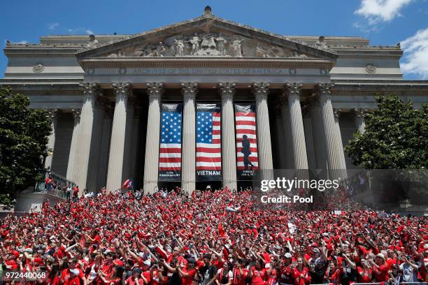 Fans crowd in front of the National Archives building as the NHL Stanley Cup champion Washington Capitals pass by on a victory parade June 12 in...