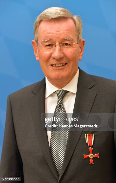 Karl Hopfner, CFO of FC Bayern Muenchen, poses with the The Federal Cross of Merit award during the Ceremony at department of the Interior on June...