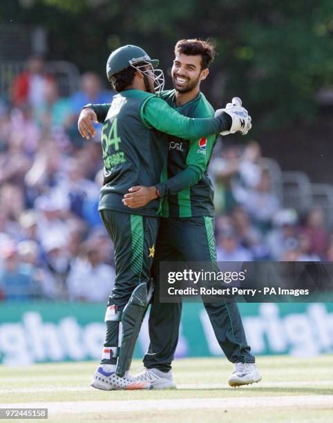 Shadab Khan of Pakistan and Sarfraz Ahmed celebrate after bowling Calum MacLeod of Scotland during the International T20 match at The Grange,...