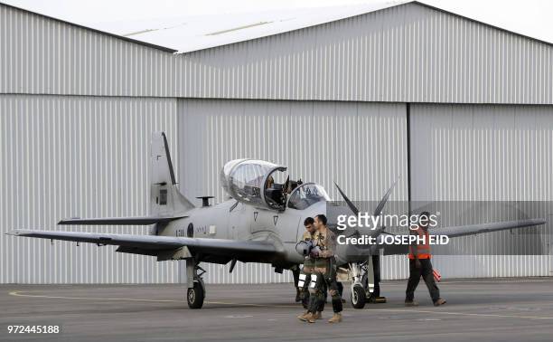 Lebanese pilots walk after disembarking from an A-29 Super Tucano aircraft after flying during a handover ceremony by the US organised by the...