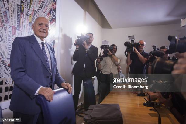 Paolo Savona, Italy's European affairs minister, left, arrives for a launch party for his book, entitled "Like A Nightmare And Like A Dream," in...