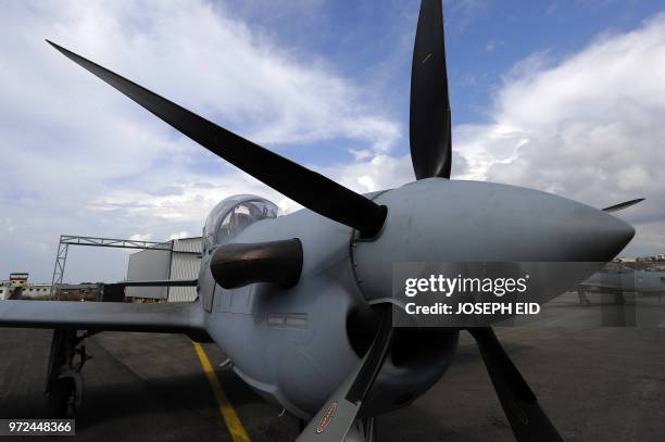 Picture taken on June 12, 2018 shows an A-29 Super Tucano aircraft parked outside a hangar during a handover ceremony by the US organised by the...