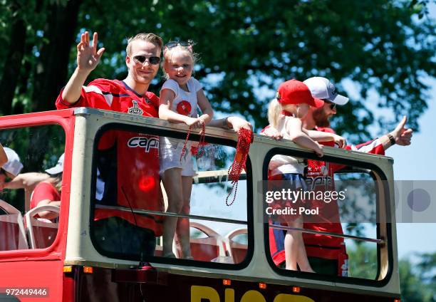 Washington Capitals center Lars Eller, left, and goaltender Braden Holtby, right, hold their children during the Stanley Cup championship victory...