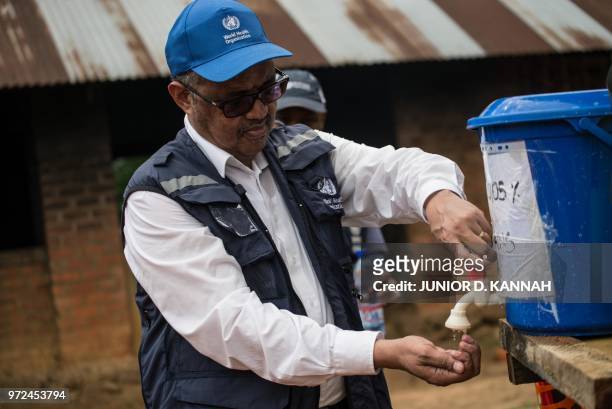 Director-General of WHO Tedros Adhanom Ghebreyesus washes his hands before visiting an Ebola treatment centre in Itipo on June 11, 2018. - The...