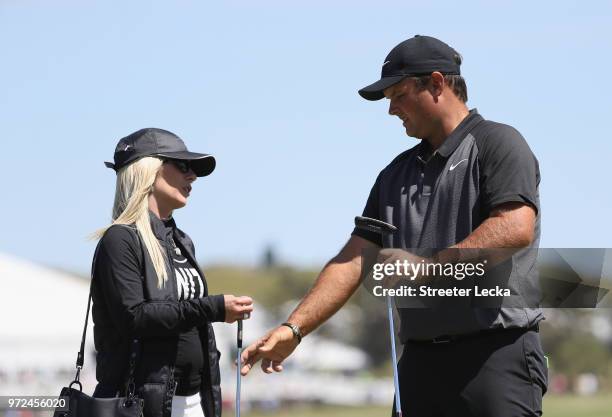 Patrick Reed of the United States talks with his wife Justine Karain during a practice round prior to the 2018 U.S. Open at Shinnecock Hills Golf...