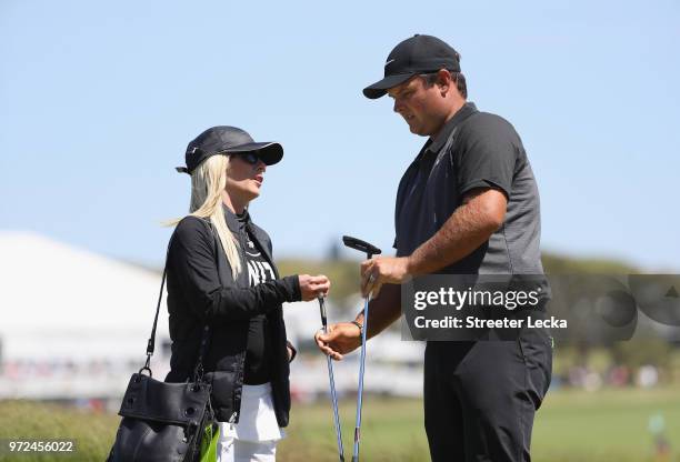 Patrick Reed of the United States talks with his wife Justine Karain during a practice round prior to the 2018 U.S. Open at Shinnecock Hills Golf...