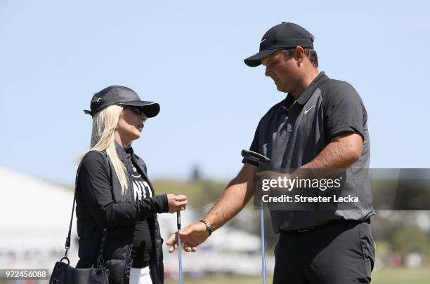 Patrick Reed of the United States talks with his wife Justine Karain during a practice round prior to the 2018 U.S. Open at Shinnecock Hills Golf...