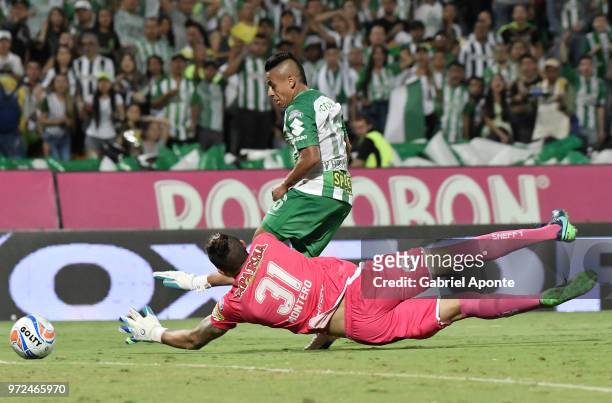 Vladimir Hernandez of Nacional tries to score over Alvaro Montero goalkeeper of Tolima during the second leg match between Atletico Nacional and...