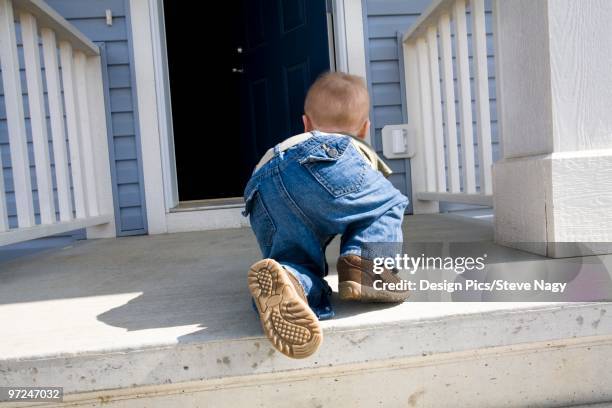 child crawling towards open door - porch railing design stock pictures, royalty-free photos & images
