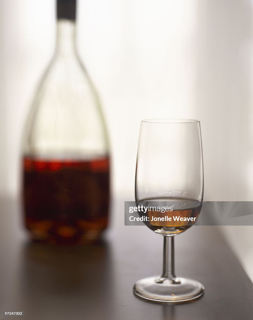Glass of cognac with bottle