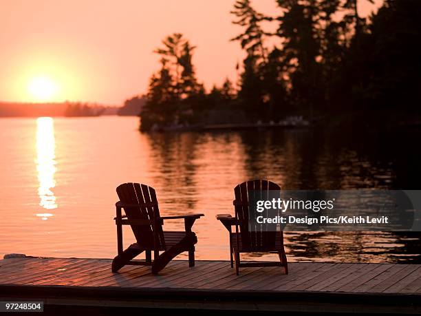 lake of the woods, ontario, canada, adirondack chairs - lake of the woods stock pictures, royalty-free photos & images