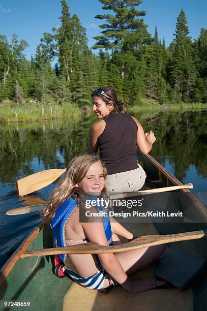 mother and daughter on a canoe, lake of the woods, ontario, canada - lake of the woods stock pictures, royalty-free photos & images