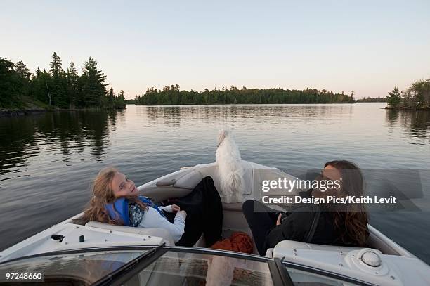 mother and daughter on a boat, lake of the woods, ontario, canada - lake of the woods foto e immagini stock