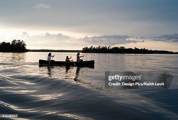 family in a canoe - lake of the woods foto e immagini stock