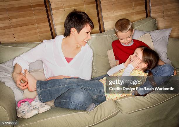 mom tickling daughter's feet - tickling feet stock pictures, royalty-free photos & images