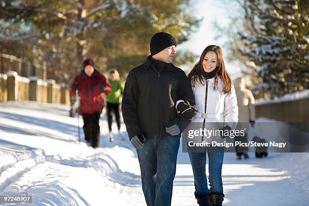 couple walking on winter paths, edmonton, alberta, canada - edmonton winter stock pictures, royalty-free photos & images