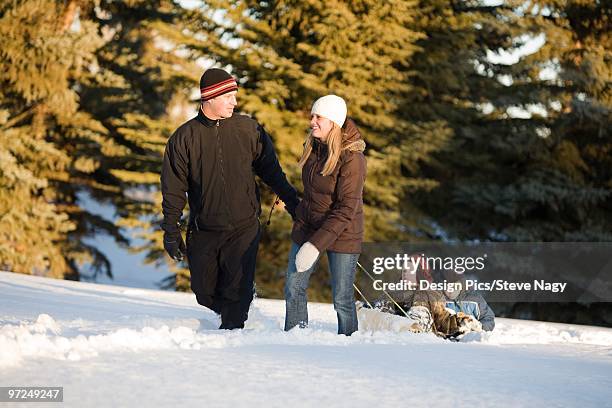 family walking in the snow - edmonton winter stock pictures, royalty-free photos & images