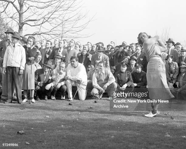 Babe Didrikson Zaharias tees off at second hole at Fresh Meadow Club in Flushing, Long Island. Holding their clubs as they watch are Sylva Annenberg,...