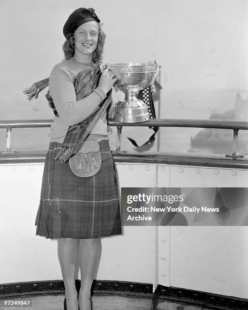 Babe Didrikson Zaharias with the Birtish Women's Amateur Championship Cup which left England for the first time.