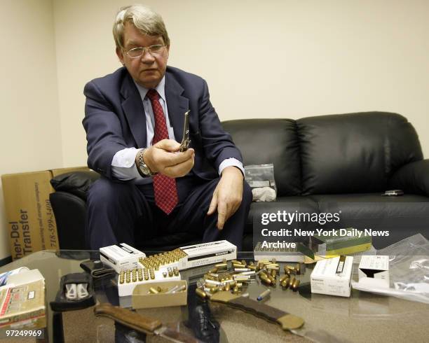 Attorney Michael Dowd in his office at 112 Madison Avenue, displays ammunition and knives found in the night table of Raymond Sheehan. Dowds client...