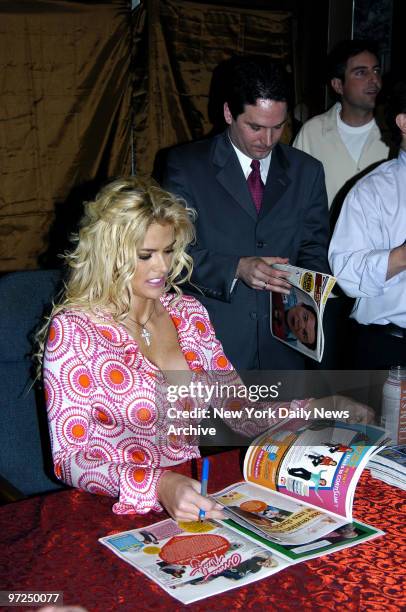 Anna Nicole Smith signs her autograph for fans at the Hudson News stand in Grand Central Terminal, where she made an appearance to launch her career...