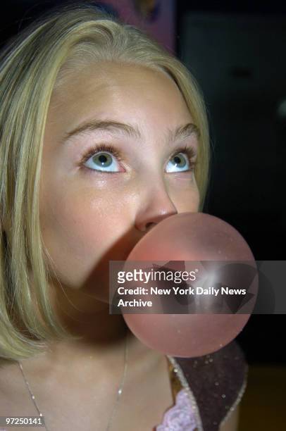 AnnaSophia Robb blows a bubble at Planet Hollywood where a bubble gum blowing contest was held to promote the new movie "Charlie and the Chocolate...