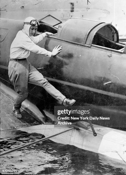 Anne Morrow Lindbergh boards monoplane for flight to Asia.