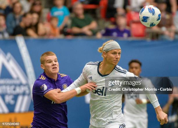 Chris Mueller of Orlando City and Brek Shea of the Vancouver Whitecapsbattle fight for the ball during a match between Orlando City SC and Vancouver...